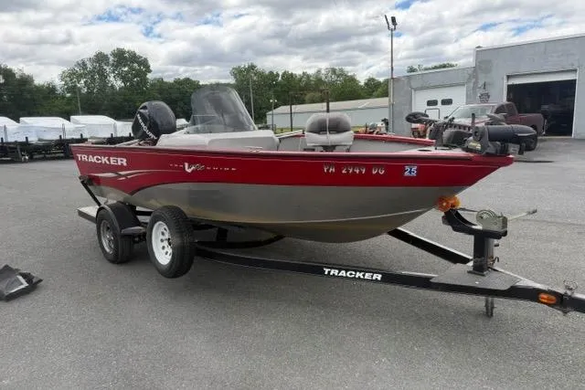 Slide: The Image of 2011 Tracker Pro Guide V-175 SC boat on trailer, parked outdoors. - 11