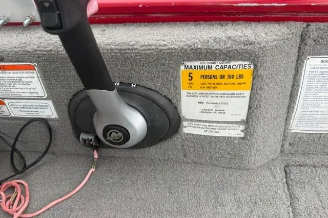 Slide: The Image of 2011 Tracker Pro Guide V-175 SC boat capacity label, steering wheel, and safety instructions. - 12