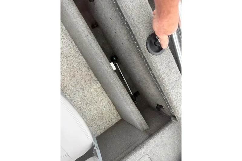 Slide: The Image of Hand opening storage compartment in 2011 Tracker Pro Guide V-175 SC boat. - 4