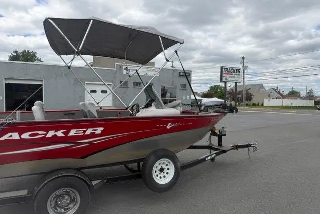 Slide: The Image of 2011 Tracker Pro Guide V-175 SC boat with canopy on trailer, parked outside dealership. - 6
