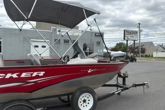 Slide: The Image of 2011 Tracker Pro Guide V-175 SC boat with canopy on trailer, parked outside dealership. - 7