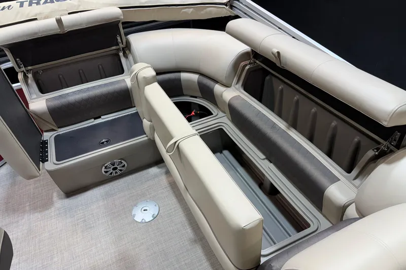 Slide: The Image of 2023 Sun Tracker Party Barge 20 DLX interior with open storage compartments and seating. - 11