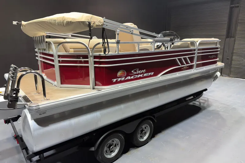 Slide: The Image of 2023 Sun Tracker Party Barge 20 DLX pontoon boat on trailer in a garage. - 4
