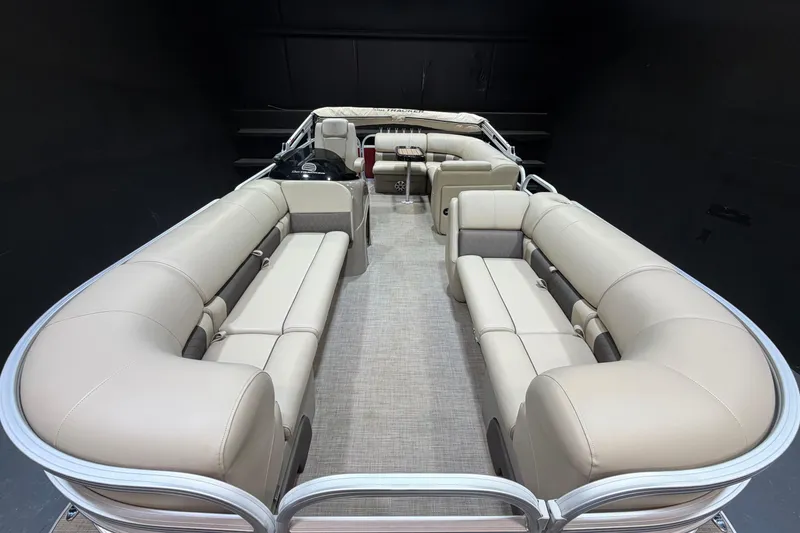 Slide: The Image of 2023 Sun Tracker Party Barge 20 DLX interior with beige seating and spacious layout. - 5