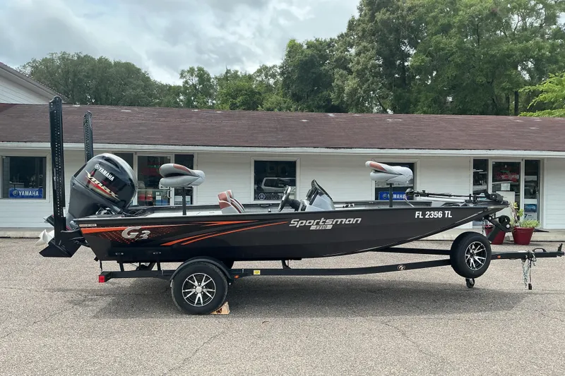 The Image of 2023 G3 Sportsman 1710 boat on trailer, parked outside a building. - 0