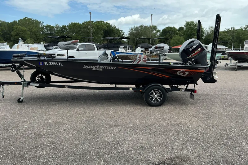 Slide: The Image of 2023 G3 Sportsman 1710 boat on trailer, parked in a marina lot. - 5