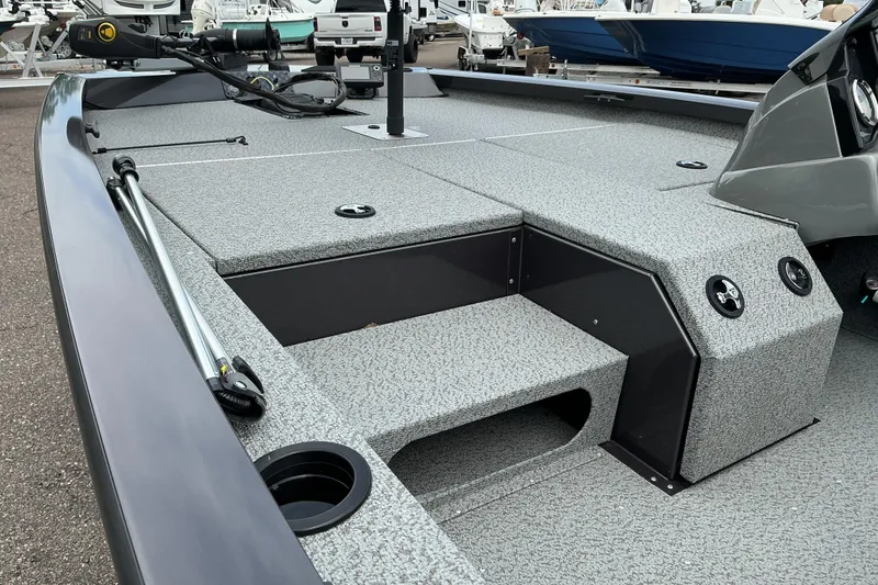 Slide: The Image of 2023 G3 Sportsman 1710 boat interior with gray textured deck and fishing equipment. - 6