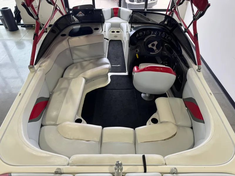 Slide: The Image of Interior of a 2001 Tigé 21 V boat with red accents. - 13