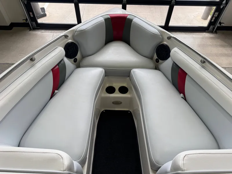 Slide: The Image of Interior of a 2001 Tigé 21 V boat with gray and red seating. - 18