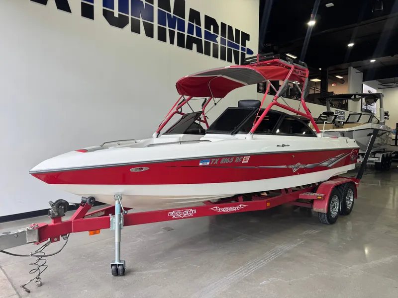 Slide: The Image of Red 2001 Tigé 21 V boat on trailer in showroom. - 2