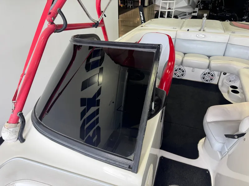 Slide: The Image of Interior of a 2001 Tigé 21 V boat with red accents. - 21