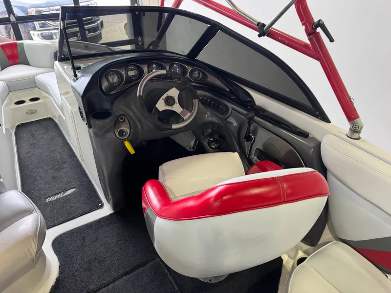 Slide: The Image of Interior of a 2001 Tigé 21 V boat with red and white seating. - 25