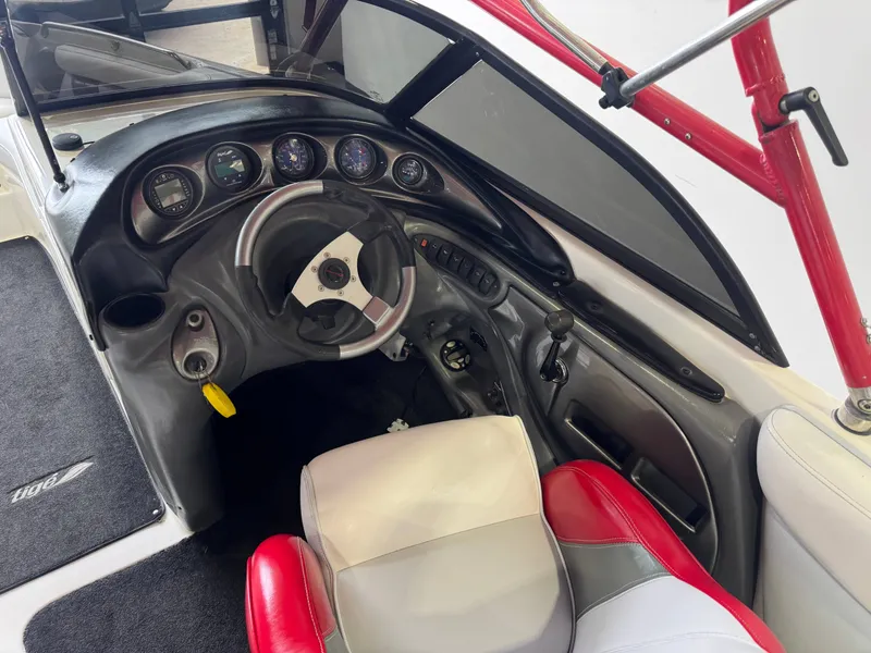 Slide: The Image of Interior of a 2001 Tigé 21 V boat with steering wheel and dashboard. - 26