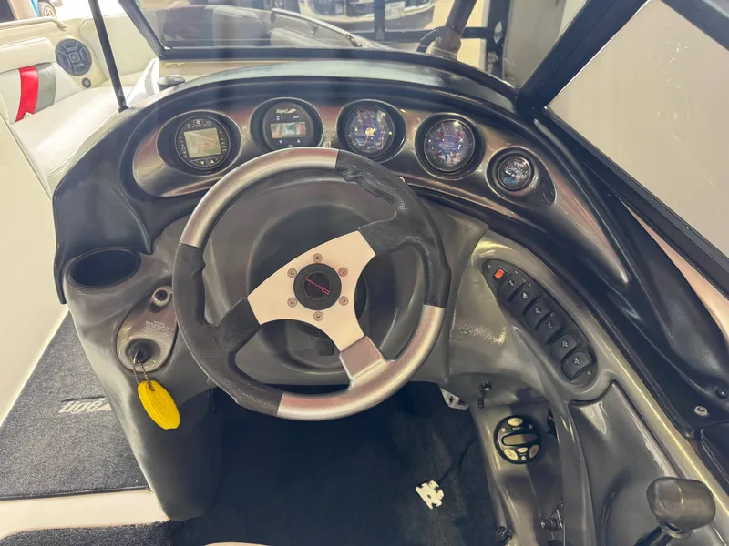 Slide: The Image of Dashboard of a 2001 Tigé 21 V boat with steering wheel and gauges. - 27