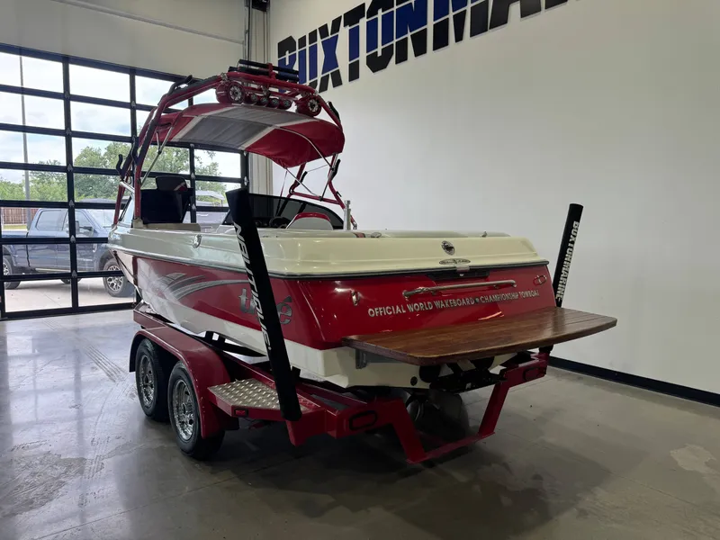 Slide: The Image of Red 2001 Tigé 21 V boat in a garage. - 5