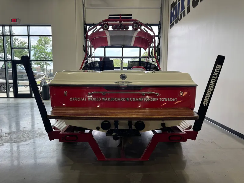 Slide: The Image of Red 2001 Tigé 21 V boat parked indoors. - 6