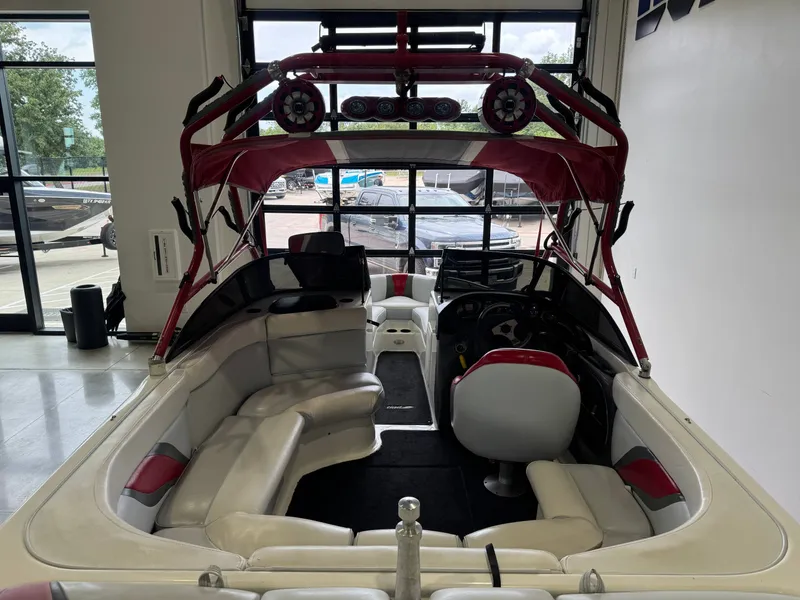Slide: The Image of Interior view of a 2001 Tigé 21 V boat with red accents. - 9