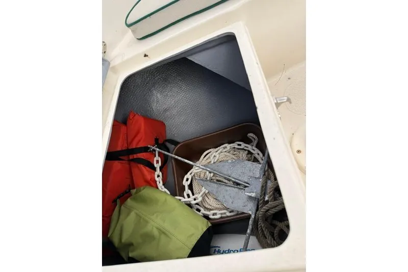 Slide: The Image of Storage compartment of a 2019 Com-Pac Picnic Cat with anchor, rope, and life jackets. - 10