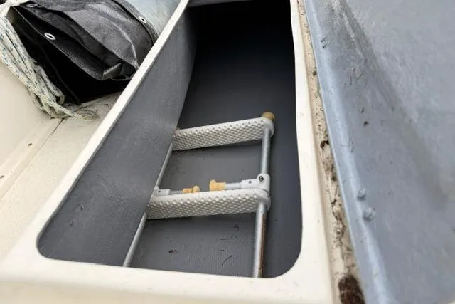 Slide: The Image of Storage compartment with ladder in 2019 Com-Pac Picnic Cat sailboat. - 11