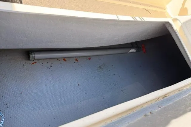 Slide: The Image of Storage compartment of a 2019 Com-Pac Picnic Cat sailboat, featuring a gray interior. - 12
