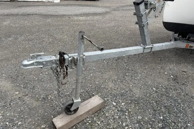 Slide: The Image of Trailer hitch of a 2019 Com-Pac Picnic Cat sailboat on gravel surface. - 15