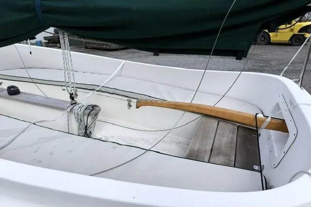 Slide: The Image of 2019 Com-Pac Picnic Cat sailboat interior with wooden tiller and rigging. - 4