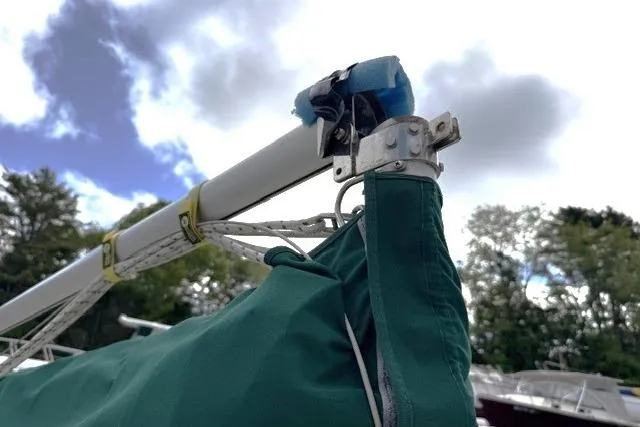 Slide: The Image of Close-up of a 2019 Com-Pac Picnic Cat sailboat mast and green sail cover. - 9