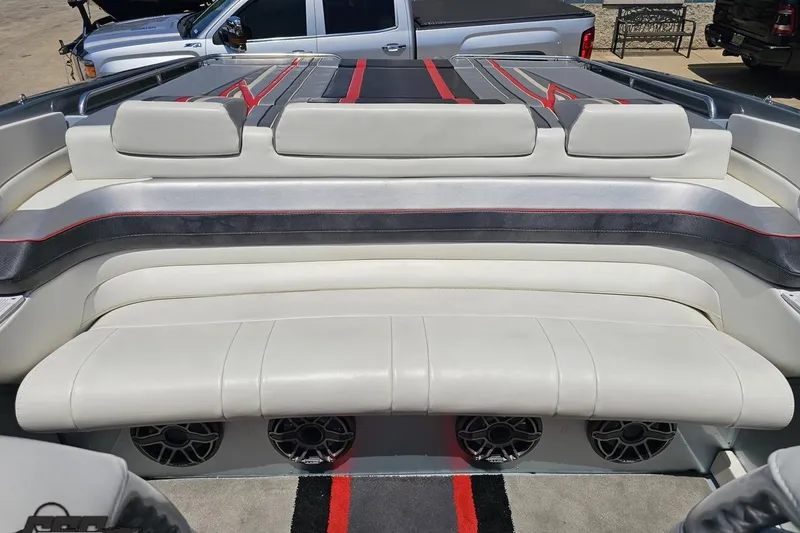 Slide: The Image of 2012 Formula 353 FASTech boat interior with white and gray seating, red accents, and speaker system. - 101