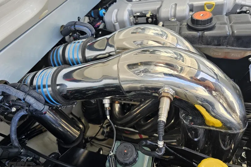 Slide: The Image of Engine components of a 2012 Formula 353 FASTech boat, featuring polished metal pipes. - 117