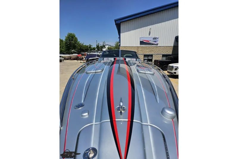Slide: The Image of 2012 Formula 353 FASTech boat with sleek silver and red design, parked outdoors. - 17