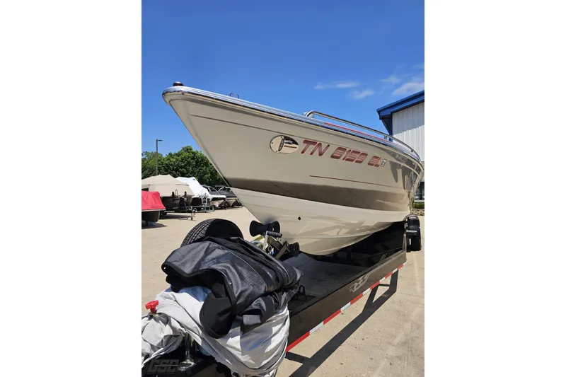 Slide: The Image of 2012 Formula 353 FASTech boat on trailer, parked outdoors under clear blue sky. - 18