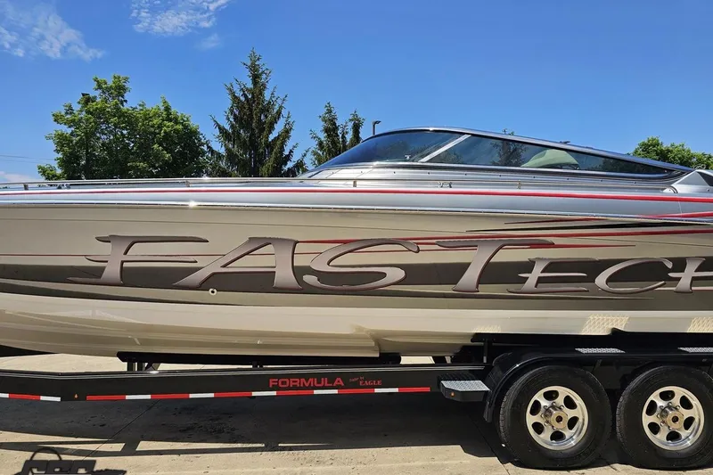 Slide: The Image of 2012 Formula 353 FASTech speedboat on trailer, sleek design with vibrant graphics. - 20
