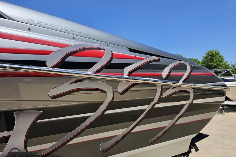 Slide: The Image of 2012 Formula 353 FASTech boat with sleek red and gray design, side view. - 22