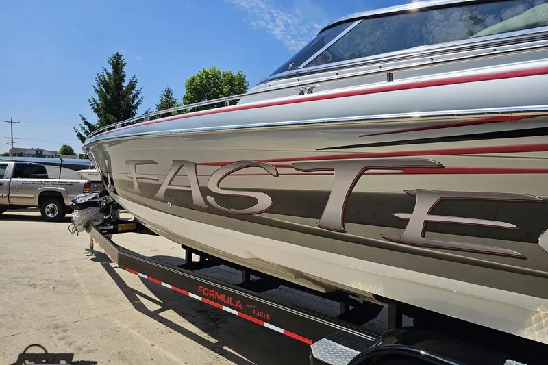 Slide: The Image of 2012 Formula 353 FASTech boat on trailer, showcasing sleek design and branding. - 24