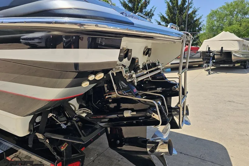 Slide: The Image of 2012 Formula 353 FASTech boat with Mercury outboard engines, parked outdoors. - 25