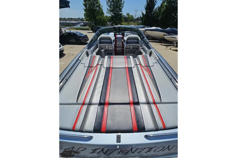 Slide: The Image of 2012 Formula 353 FASTech boat with sleek red and gray upholstery, docked outdoors. - 38