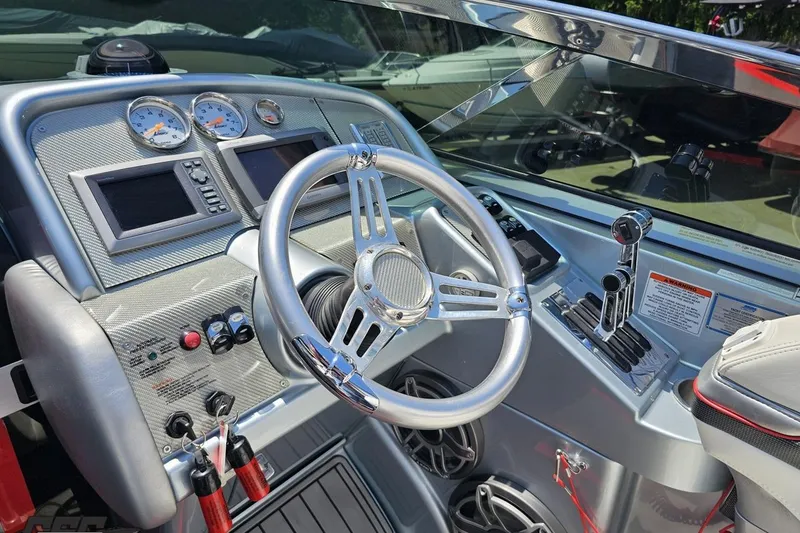 Slide: The Image of 2012 Formula 353 FASTech boat dashboard with chrome steering wheel and control panel. - 61