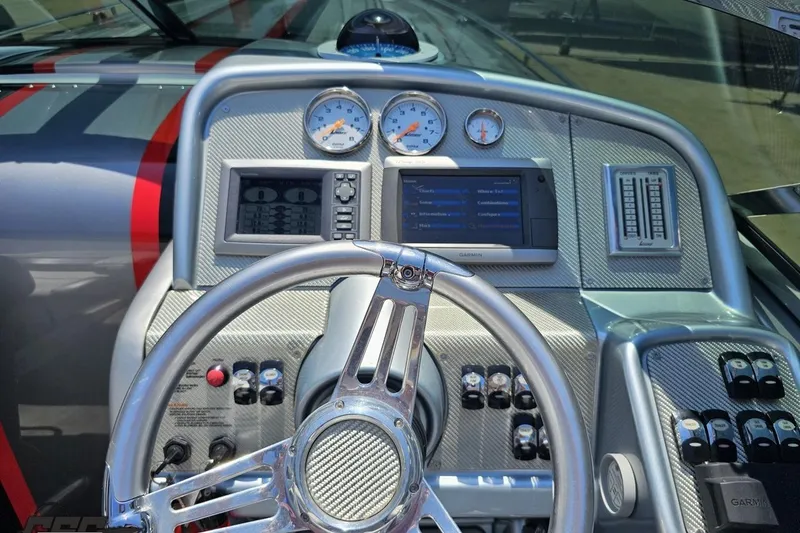 Slide: The Image of Steering wheel and dashboard of 2012 Formula 353 FASTech boat with gauges and controls. - 64