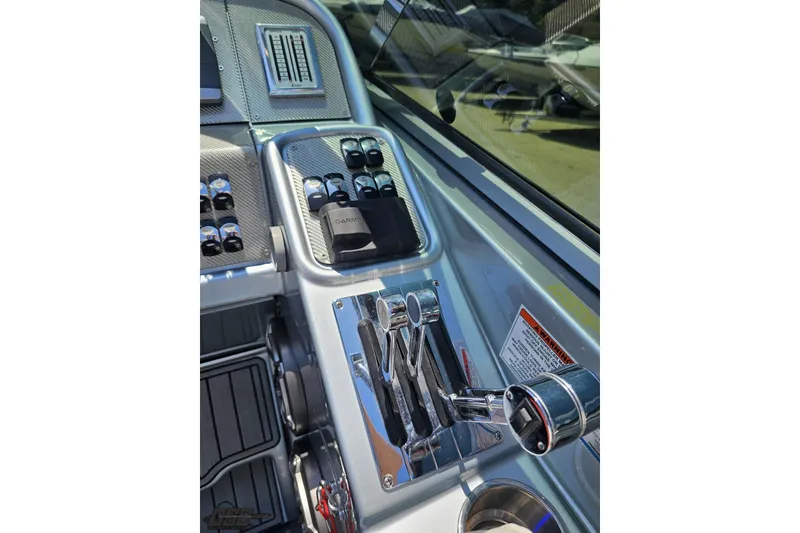 Slide: The Image of Control panel of a 2012 Formula 353 FASTech boat with Garmin device and throttle levers. - 68