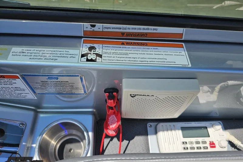 Slide: The Image of Control panel of a 2012 Formula 353 FASTech boat with safety warnings and equipment. - 69