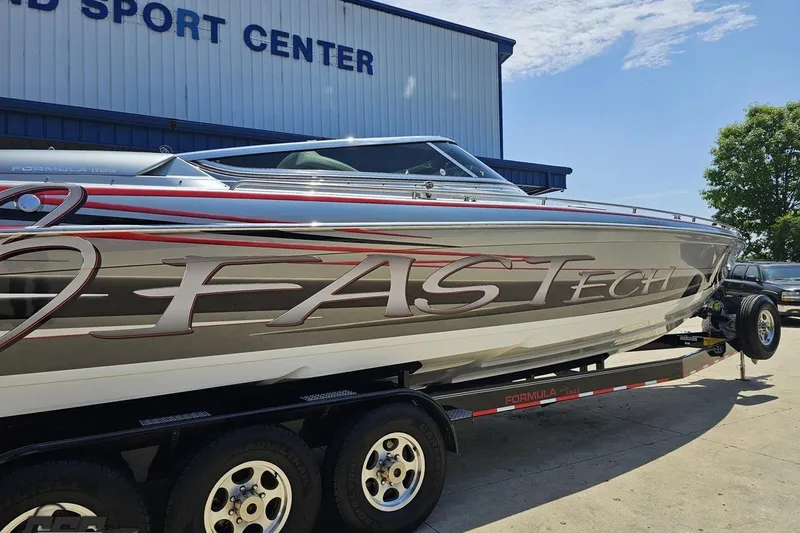 Slide: The Image of 2012 Formula 353 FASTech boat on trailer at a sport center, side view. - 8