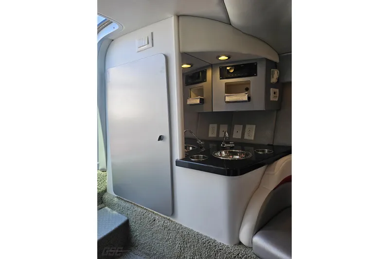 Slide: The Image of Interior of 2012 Formula 353 FASTech boat featuring a compact kitchenette with sink and storage. - 80