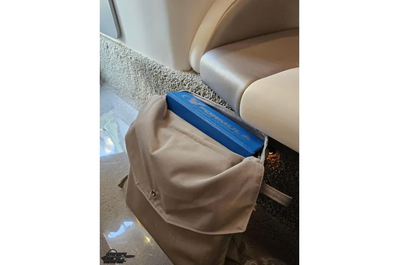 Slide: The Image of Beige bag with blue Formula 353 FASTech 2012 item inside, near beige seat. - 93