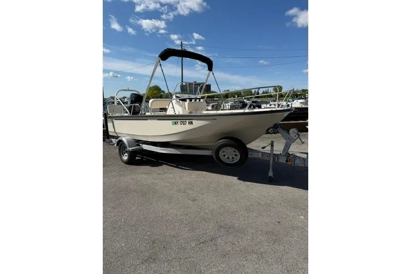 The Image of 2021 Boston Whaler 170 Montauk boat on trailer under clear blue sky. - 0