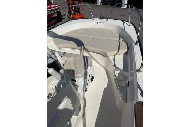 Slide: The Image of 2021 Boston Whaler 170 Montauk boat interior with cushioned seating and storage. - 10