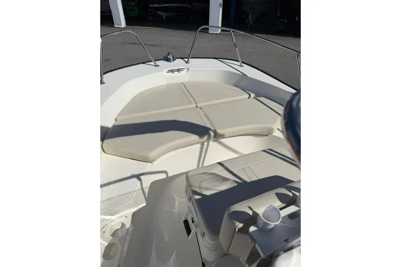 Slide: The Image of 2021 Boston Whaler 170 Montauk boat interior with cushioned seating and railings. - 11