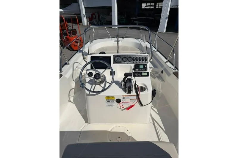 Slide: The Image of 2021 Boston Whaler 170 Montauk boat console with steering wheel and controls. - 14