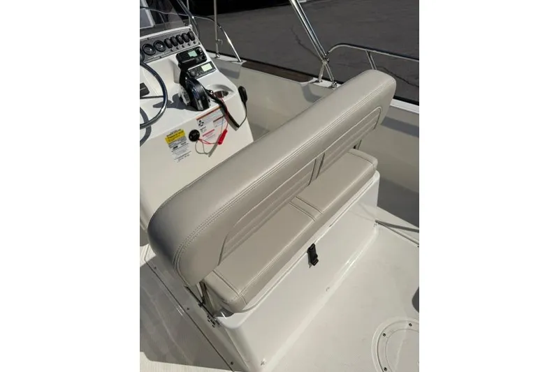 Slide: The Image of 2021 Boston Whaler 170 Montauk boat interior with beige seating and control panel. - 15