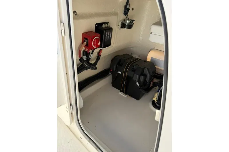 Slide: The Image of Interior view of a 2021 Boston Whaler 170 Montauk boat compartment with battery and wiring. - 17