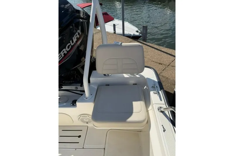 Slide: The Image of 2021 Boston Whaler 170 Montauk boat seat and motor by the water. - 5